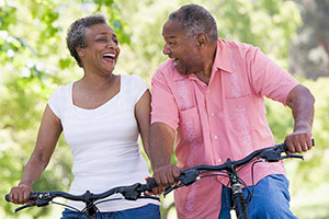retired couple riding a bike